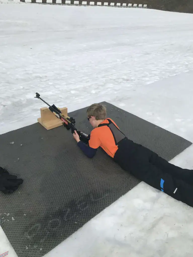 Guest taking part in a biathlon shooting experience in Méribel during a winter holiday near La Petite Cachée in the Three Valleys, France.